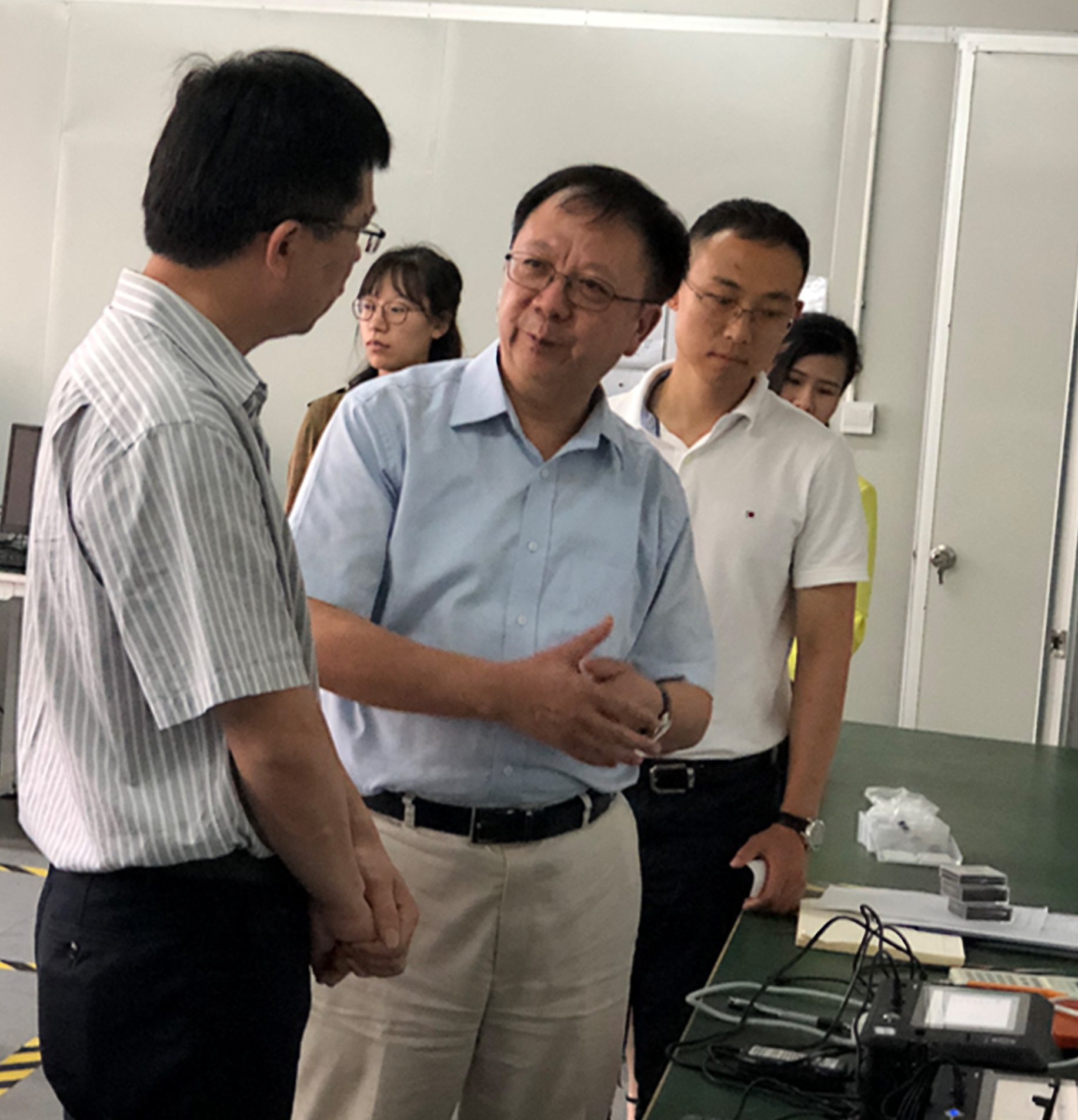 Prof. WEN (Middle) and Dr. GAO (right) introduce the theories behind their novel detection device in their research base at Shenzhen.